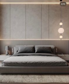 a large bed sitting in the middle of a bedroom next to a wall mounted light