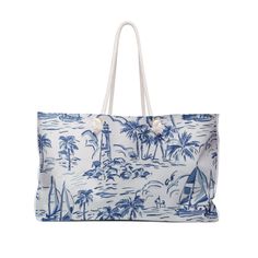 a blue and white tote bag with palm trees on it, in front of a white background