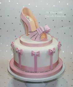 a pink and white cake with high heels on top