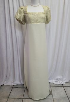 We offer a Regency styled gown, with the empire waist and short puffed sleeves.  This beautiful dress has a yellow embroidered lace overlay on the top and is fully lined.  The neckline has been trimmed with yellow lace trim.  The skirt is a solid pale yellow.      *This gown ties at the back with ribbons which can adjust the fit.      * All seams have been finished and this gown is spot clean or dry clean only.   If you have any questions about this dress, or any of our listings, please convo us White Short Sleeve Dress For Debutante Ball, Regency Style Empire Waist Wedding Gown, Formal White Gown With Short Sleeves, White Short Sleeve Formal Gown, Formal Fitted Gown With Empire Waist, White Gown With Fitted Bodice And Short Sleeves, Empire Waist Fitted Gown For Evening, Formal Fitted Empire Waist Gown, Fitted Empire Waist Evening Gown