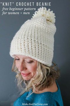 a woman wearing a white knitted hat with pom - pom on it