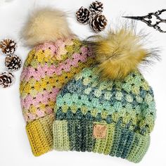 three knitted hats with pine cones and scissors