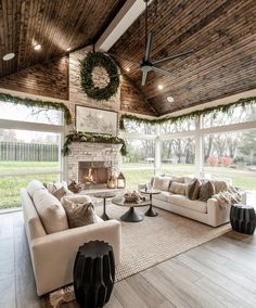 a living room filled with furniture and a fire place in the middle of an open floor plan