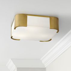 a ceiling light that is hanging from the ceiling in a room with white walls and ceilings