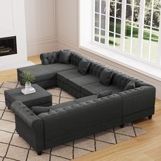 a large sectional couch sitting on top of a rug in front of a fire place