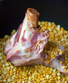 a piece of meat sitting on top of corn