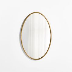 a round mirror hanging on the wall