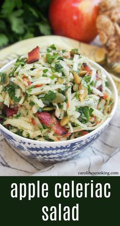 apple celery salad in a blue and white bowl on a table with apples