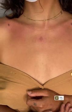 a close up of a woman wearing a tan bra with stars on it's chest