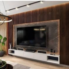 a living room with a large flat screen tv mounted to the side of a wall