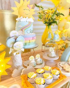 a table topped with lots of cakes and cupcakes