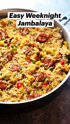 a pan filled with rice and sausage on top of a table