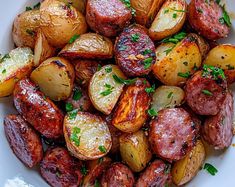 a white bowl filled with cooked potatoes and parsley