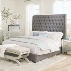 a bedroom with a bed, dresser and mirror in it's centerpieces