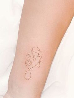 a woman's arm with a small tattoo on it