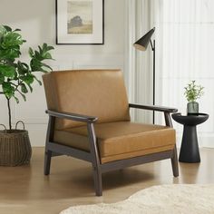 a living room with a chair and potted plant