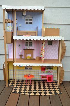 the doll house is made out of cardboard