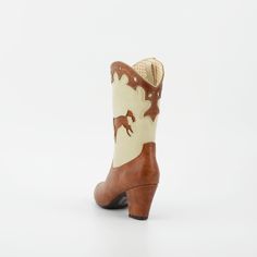 1950's Inspired Bucking Horse Adorned Western Boots. Proud To Be 100% Vegan Friendly. Upper Material: Faux Textured Leather Lining: Man Made + Fabric Step In Boot w/ Inner Tab For Easy Access. Heel Height: 3" Inches Approximate Shaft Height: (based on size 6 from top to back counter) 7 1/2" Inches / Mid Calf Height Fits True To Size, Please Size Up 1/2 If You Take A Wider Width. For Any Sizing Suggestions, Please Contact Customer Care. Imported Retro Spring Heeled Boots With Pointed Toe, Retro High Heel Fitted Boots, Vintage Fitted Heeled Boots For Rodeo, Retro Fitted High Heel Boots, Retro Fitted High Heeled Boots, Retro Styled Pointed Toe Fitted Heeled Boots, Retro Style Fitted Heeled Boots With Pointed Toe, Retro Fitted Heeled Boots With Pointed Toe, Retro Fitted Boots For Rodeo