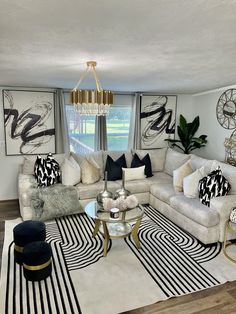 a living room with couches, chairs and rugs in front of a window