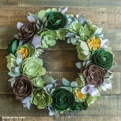 a wreath made out of green and brown flowers