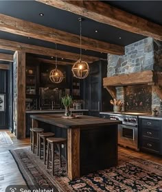 a large kitchen with an island in the middle and two pendant lights hanging from the ceiling