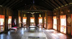 the inside of a house with wooden floors and windows