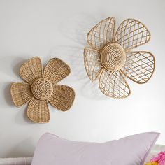 two wicker flower wall hangings on the wall