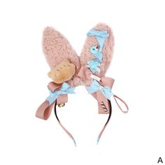 a pair of pink mittens with a teddy bear attached to the front and side