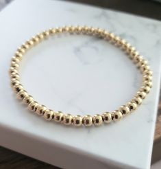 4mm gold filled delicate ball bead bracelet, expandable  one size fits most. Everyday Hypoallergenic Gold Bracelet With Round Beads, Minimalist Stackable Stretch Bracelet With Round Beads, Minimalist Everyday Jewelry With Round Beads, Minimalist Stretch Bracelet With Round Beads, Minimalist Stackable Bracelets With Round Beads, Classic Adjustable Jewelry With 8mm Beads, Minimalist Everyday Bracelet With 8mm Beads, Minimalist Everyday Bracelets With 8mm Beads, Minimalist Stretch Bracelet With Round Beads For Everyday