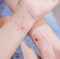 two wrist tattoos with the sun and moon on each one side, both showing their matching hands