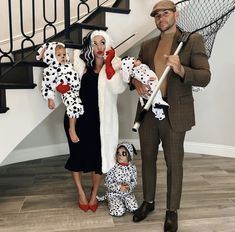 a man and two women dressed up as dalmatian with babys in costumes