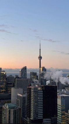 the city skyline is covered in fog and smoggy clouds at sunset, as seen from above