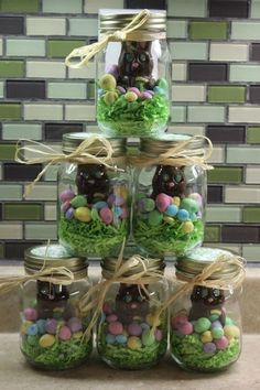 a stack of mason jars filled with candy and candies