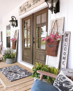 the front porch is decorated with flowers and plants