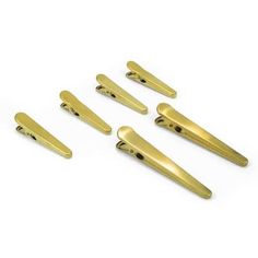 six gold colored metal handles on a white background