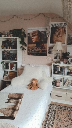 a bedroom with a bed, bookshelf and pictures on the wall above it