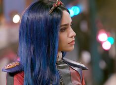 a close up of a person with blue hair wearing a leather jacket and headband