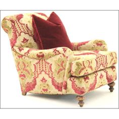 a red and white chair with a pillow on it's backrest, sitting in front of a white background