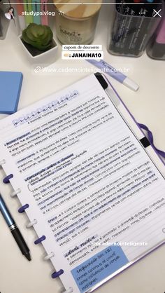 a notepad sitting on top of a desk next to a pen