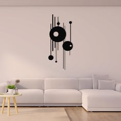 a living room with a white couch and black clock on the wall