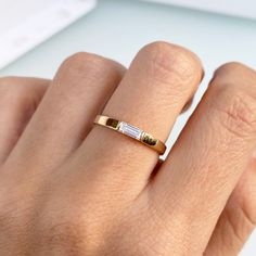 a woman's hand with a gold and white diamond ring