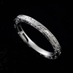 a wedding band with intricate engraving on it