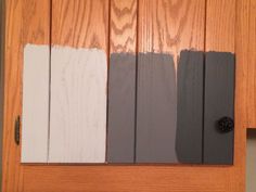 three different colors of paint on the side of a wooden door with wood paneling