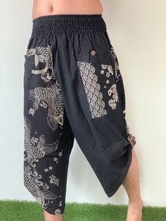 "Samurai Pants (Unisex) Elastic Waist - Fits all ! MATERIAL: 100% Cotton APPROX MEASUREMENT: Measurements - 1 inch (1\") = 2.54cm. Waist: 24\"- 40\" Length: 28\" Around Ankle: 18 inch (Reference of the model) Tall 5'8\" Waist 33\" Category: harem pants, Japanese, ninja pants, pants, samurai, samurai pants, samurai-pants-elastic-waist, thai pants Shipping & Handling ❤️❤️❤️ Parcels will be ship via DHL Express ❤️❤️❤️❤️ Shipping : - All item will be shipped in 1 business days after receiving pa Samurai Pant Apron, Black Parachute Pants With Pockets For Festival, Black Cotton Harem Yoga Pants, Black Cotton Harem Pants For Yoga, Black Harem Pants With Pockets For Festival, Black Harem Pants For Festival, Traditional Black Wide Leg Bottoms, Traditional Black Harem Pants For Yoga, Black Cotton Harem Pants For Festival