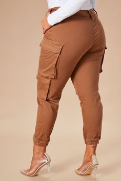 Kalley Cargo Pants - Tan | Fashion Nova, Pants | Fashion Nova Stretch Brown Cargo Pants With Pockets, Brown Stretch Cargo Bottoms, Stretch Brown Bottoms With Cargo Pockets, Non-stretch Brown Pants With Side Pockets, Non-stretch Brown Bottoms With Side Pockets, Brown Non-stretch Bottoms With Side Pockets, Mid-rise Sweatpants With Pockets For Fall, Fall Mid-rise Sweatpants With Pockets, Non-stretch Utility Trousers