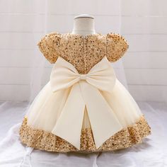 Be the star of the party with our Big Bow Gold Sequins Party Dress! This glitzy and elegant dress features a stunning gold sequin design with a playful bow and delicate lace tutu. Perfect for first birthdays, weddings, proms, or Christmas events. Crown your little princess with this dress and watch her shine! Material: Polyester Size : in inches available in image gallery Girls First Communion Dresses, Birthday Princess Dress, Toddler Tutu, Baby Girls Dress, Custom Bridesmaid Dress, Pregnant Wedding Dress, First Communion Dress, Christmas Events, Birthday Princess