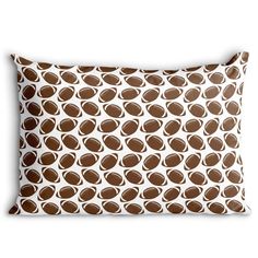 a brown and white pillow with circles on it