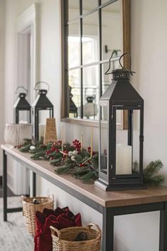 a mantle with candles and christmas decorations on it, along with other holiday decor items