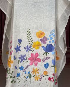 a white table cloth with colorful flowers on it