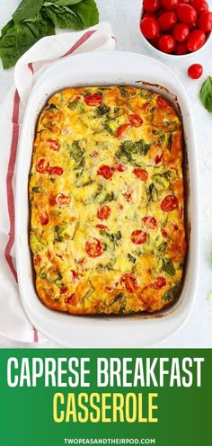 a casserole dish with tomatoes and spinach on the side